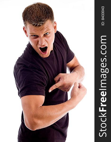 Shouting man pointing at his muscles against white background