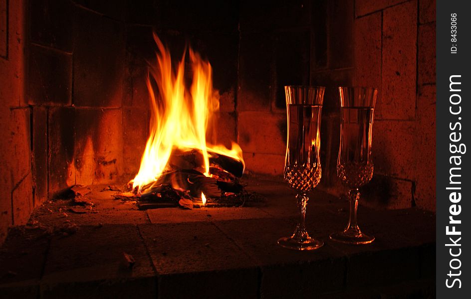Cups of champagne by the fireplace
