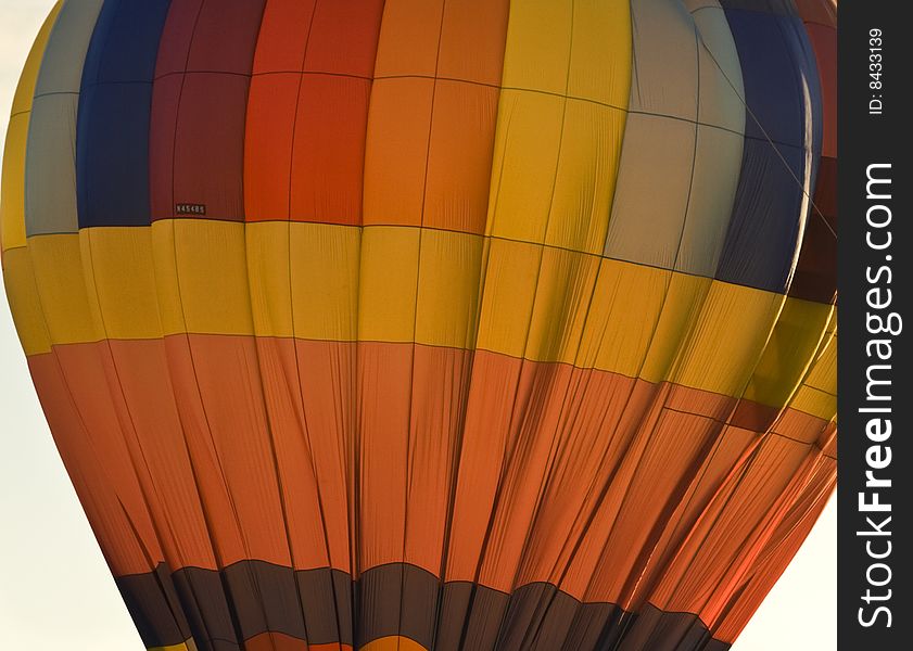 Hot air balloon, lit from behind, preparing for take-off. Hot air balloon, lit from behind, preparing for take-off.