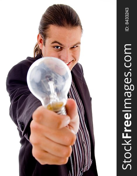 Young male holding electric bulb against white background