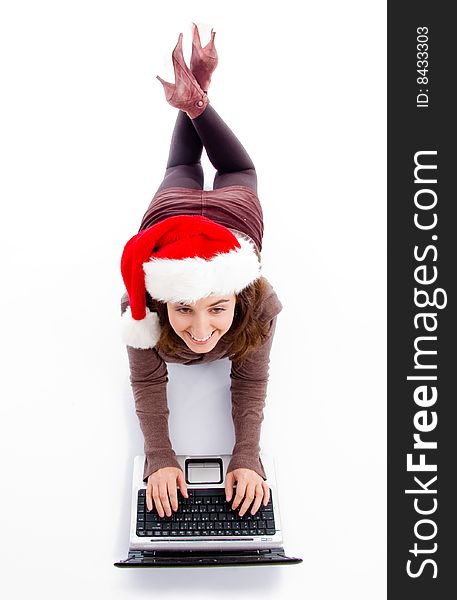 Female lying on floor working on laptop against white background