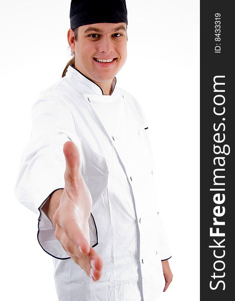 Portrait of young chef offering handshake
