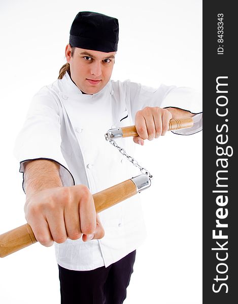 Chef holding nunchaku in fighting stance with white background