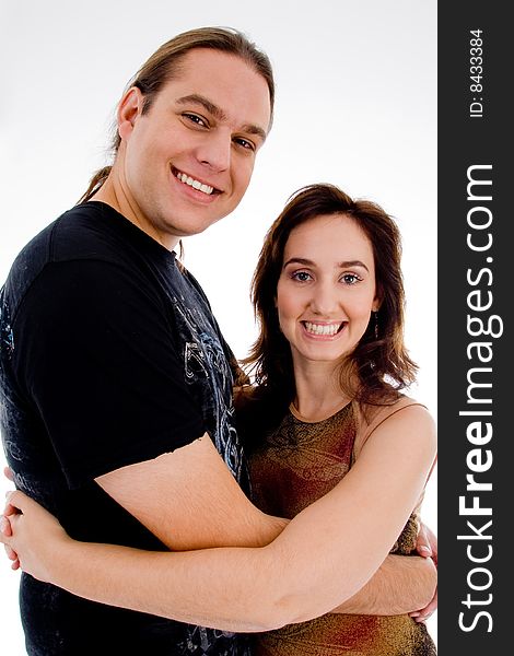 Smiling playful young couple on an isolated white background