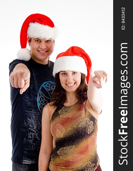 Pointing couple wearing christmas hat