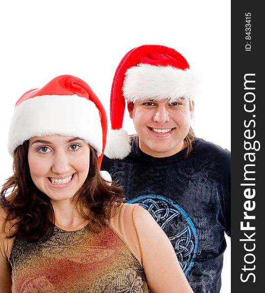 Brunette happy couple wearing christmas hat on an isolated white background