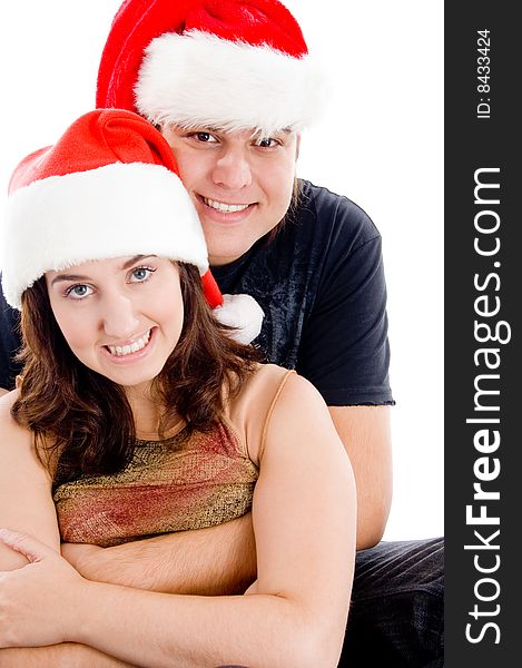Couple with christmas hat and looking at camera on an isolated white background