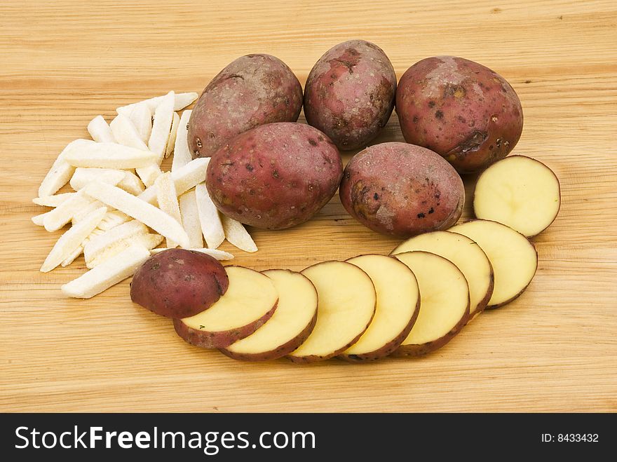 Red potato whole,slice and ripper on wood table background.Check out also <a href=http://www.dreamstime.com/healthy-food-rcollection8217-resi828293>Healthy food</a>