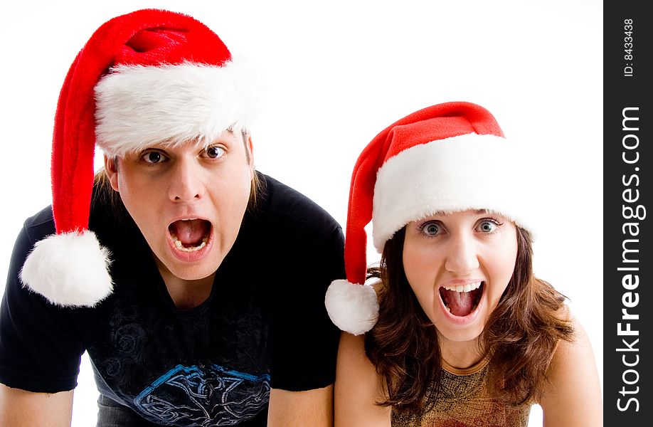 Portrait of shouting couple wearing christmas hat on an isolated background