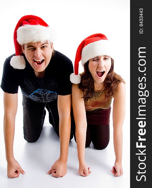 Winking young couple wearing christmas hat on an isolated white background