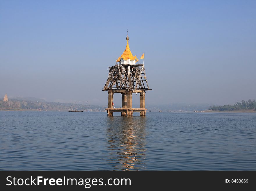 The old bell tower underwater at Kanchanaburi, Thailand. The Thai architectural structure built in Wat for signaling the Monks to do their praying. The old bell tower underwater at Kanchanaburi, Thailand. The Thai architectural structure built in Wat for signaling the Monks to do their praying.