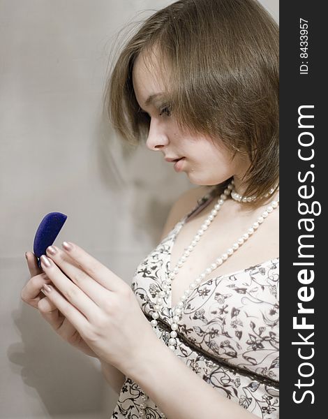 Girl holds the blue sheath with a ring. Girl holds the blue sheath with a ring