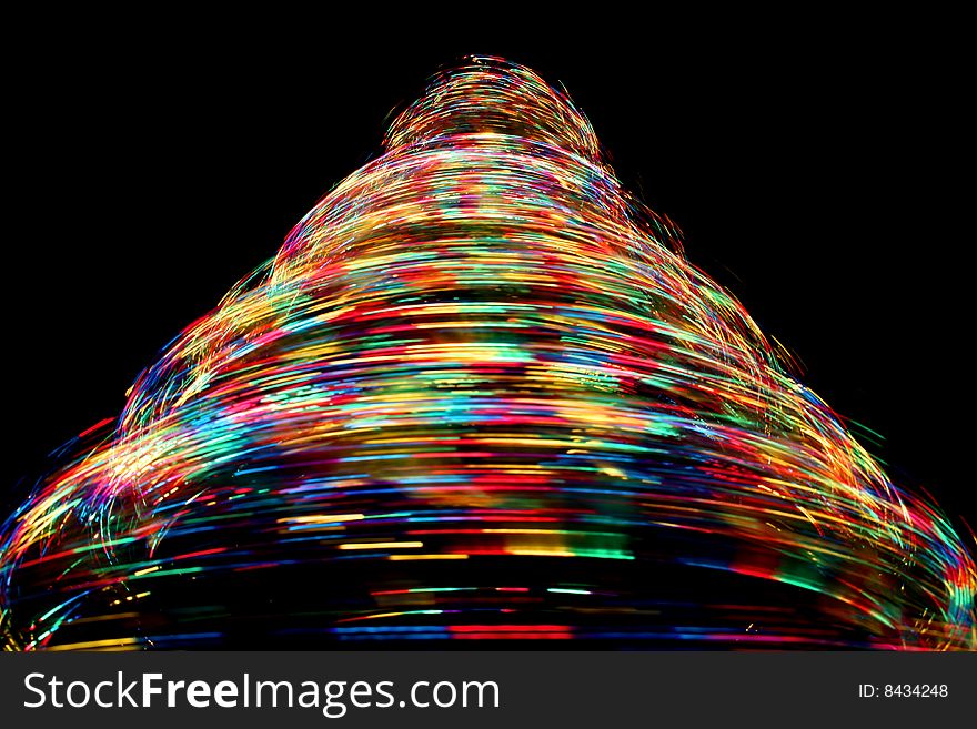 Long exposure photograph looking up at a rotating optical fibre christmas tree with cycling colours. Long exposure photograph looking up at a rotating optical fibre christmas tree with cycling colours.