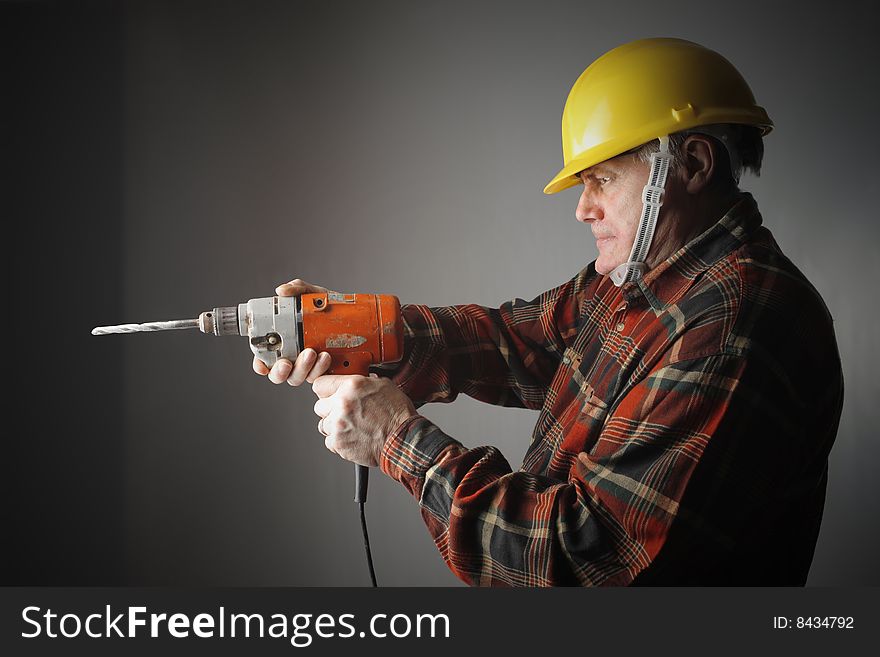 A worker using an electric drill