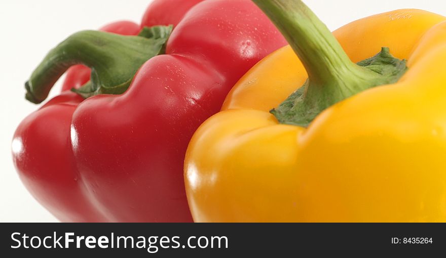 Red and yellow peppers in isolated background