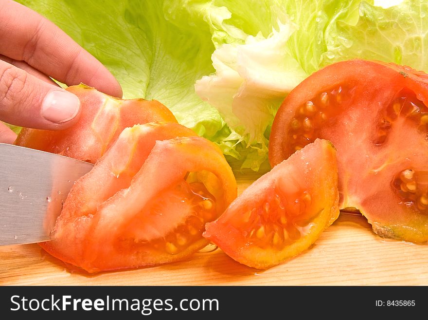 Tomatoes with salad cut by a man