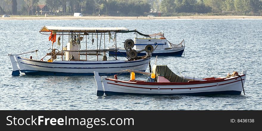 Three fishing boats, coastal scenic