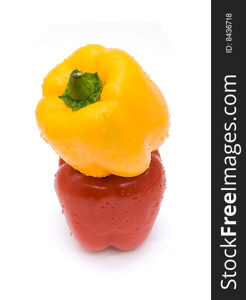 Red and yellow peppers with water drops isolated