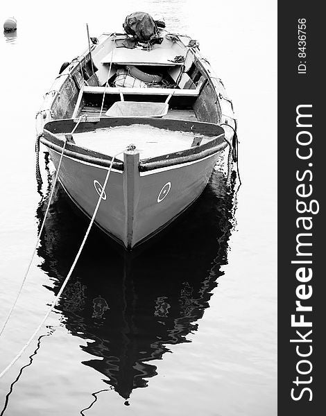 Vertical view of a traditional portuguese fishing boat, anchored on the docks. Vertical view of a traditional portuguese fishing boat, anchored on the docks.