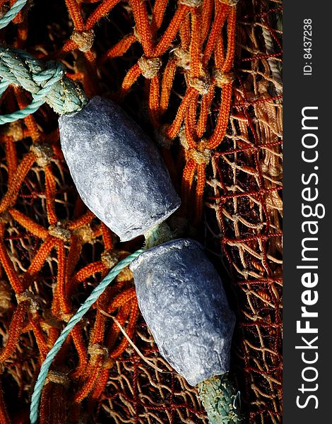 Close view of some fishing net and some weight floaters. Close view of some fishing net and some weight floaters.