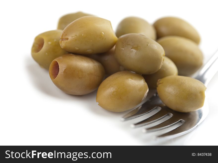 Heap of green olives isolated on white