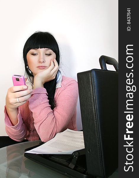 Young businesswoman talks on a mobile telephone