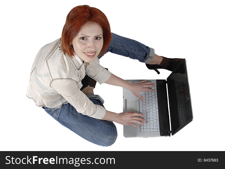 Red-haired woman with laptop looking at the camera over white. Red-haired woman with laptop looking at the camera over white
