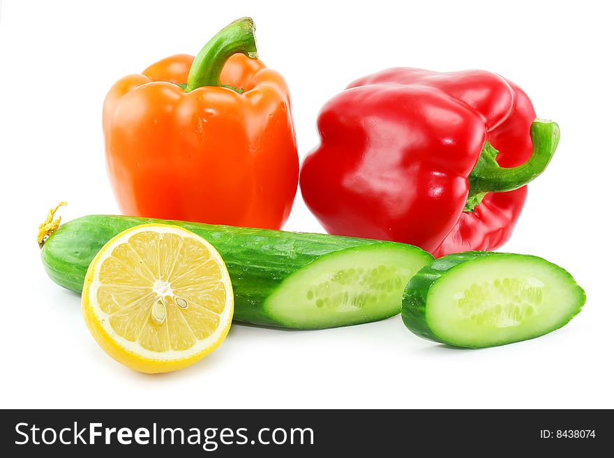 Fresh vegetables fruits (paprika, cucumber and lemon) isolated on a white background. Shot in a studio. Fresh vegetables fruits (paprika, cucumber and lemon) isolated on a white background. Shot in a studio.