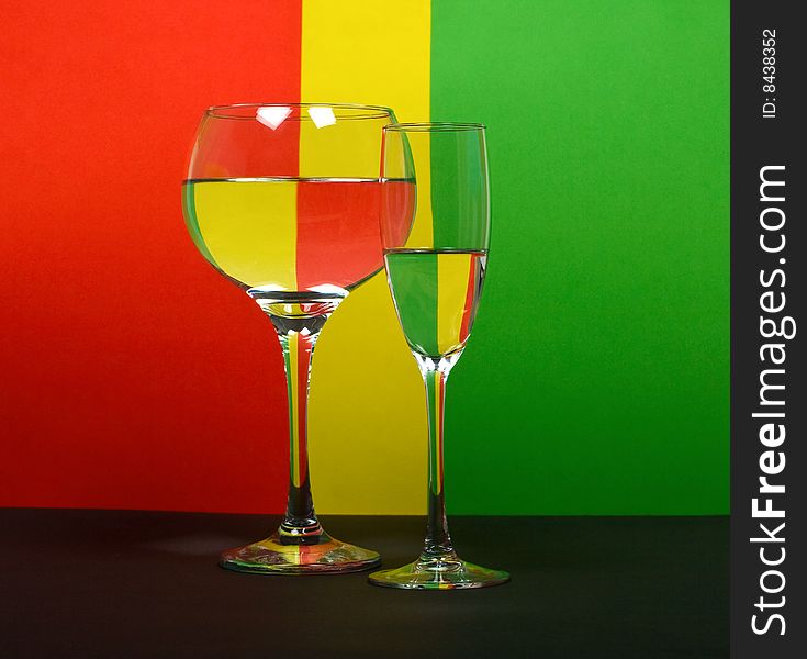Two wineglass in color background
