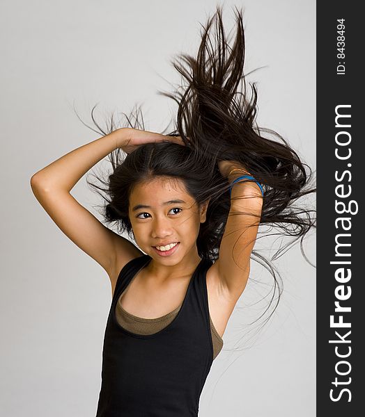 Thai teenager flipping hair over her shoulder. Thai teenager flipping hair over her shoulder