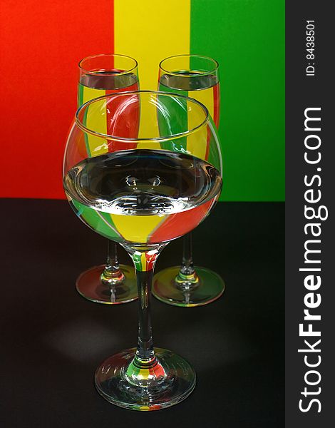 Three wineglass on color background