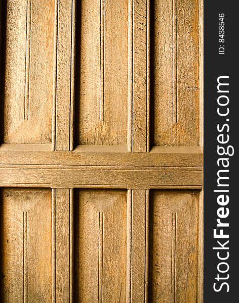 Ancient gothic wooden door panel with texture from side lighting. Ancient gothic wooden door panel with texture from side lighting