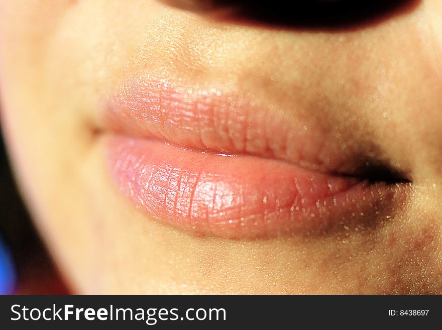 Closeup shot of the lips of a young adult woman. Closeup shot of the lips of a young adult woman.