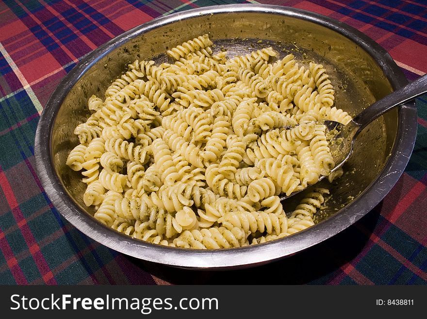 Italian recipe: pasta with pesto sauce. It is made with basil, pine nuts and garlic. Italian recipe: pasta with pesto sauce. It is made with basil, pine nuts and garlic.