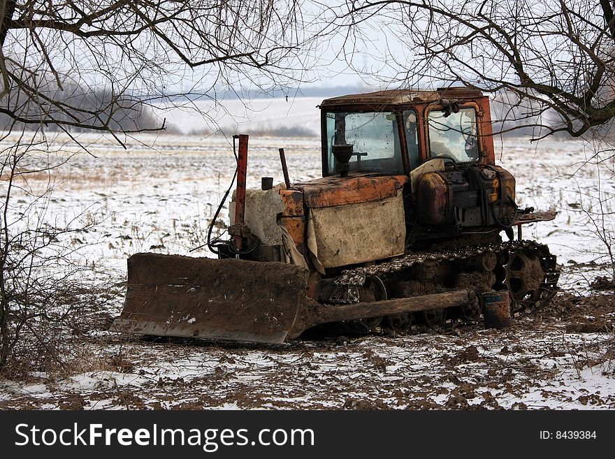 Tractor in the field villages near Buzhanka, Ukraine. By sight very old, but nevertheless works