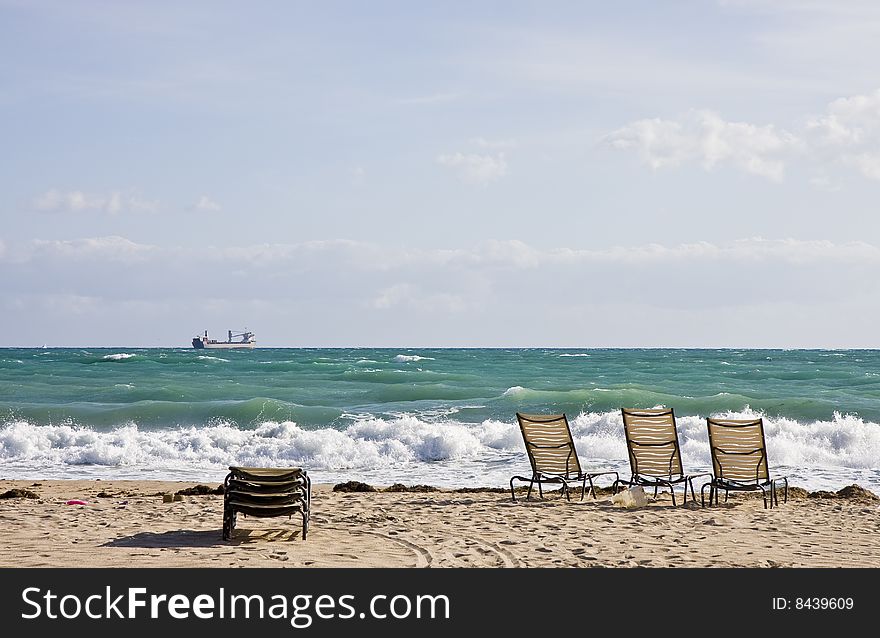 Chairs On Beach And Freighter