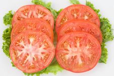 Tomato Slices On Green Royalty Free Stock Photography
