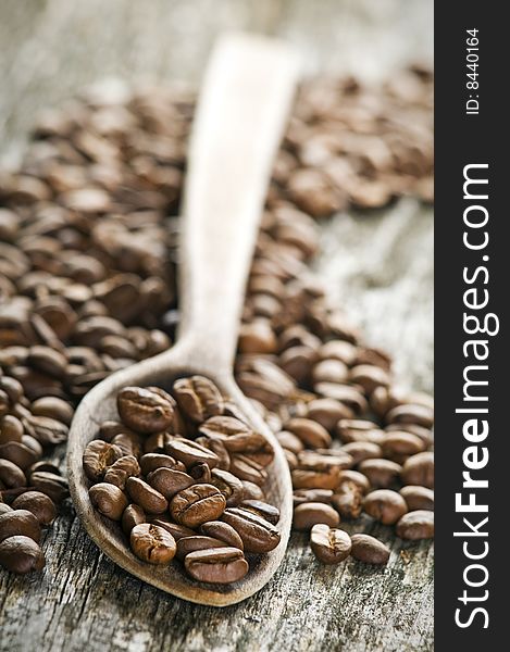 Coffee beans on wooden board close up shoot