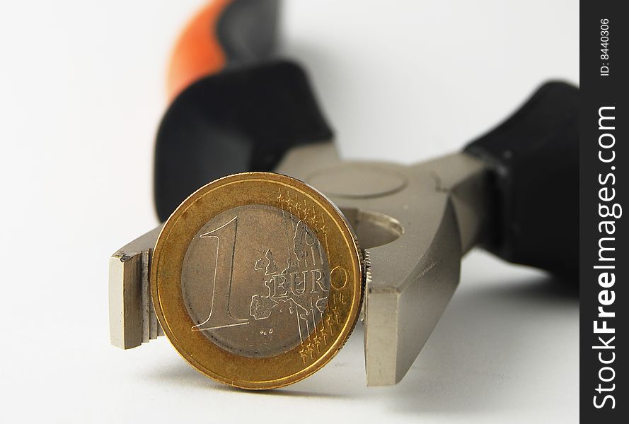 Euro coin in combination pliers on white background