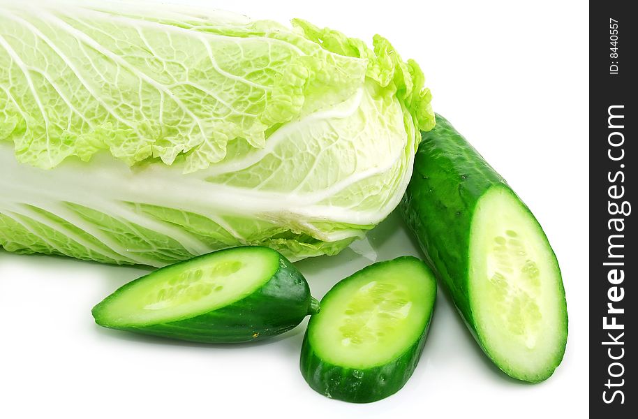 Fresh vegetables (chinese cabbage and sliced cucumber) isolated on a white background. Shot in studio. Fresh vegetables (chinese cabbage and sliced cucumber) isolated on a white background. Shot in studio