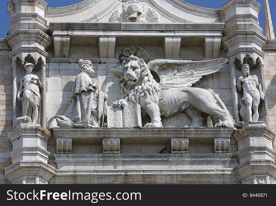 A Lion and holy man sculpture on Italian building. A Lion and holy man sculpture on Italian building