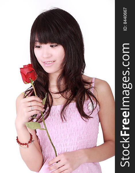 A beautiful Asian girl  holds a red rose on white background. A beautiful Asian girl  holds a red rose on white background.