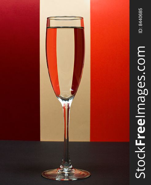 One Wineglass In Color Background
