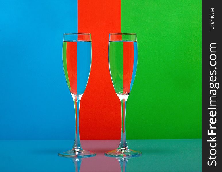 Two wineglass in color background