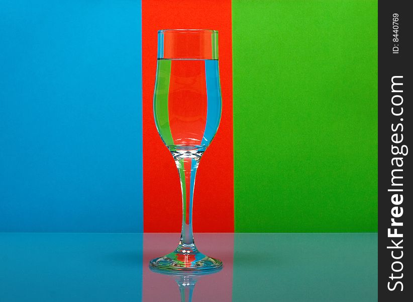 One wineglass on color background