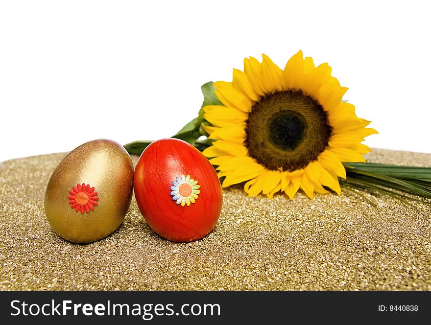 Easter spring celebration with red and golden decorated eggs and sunflower. Isolated over white with clipping path included. Easter spring celebration with red and golden decorated eggs and sunflower. Isolated over white with clipping path included.