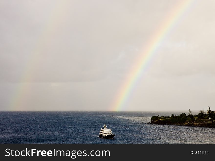 Rainbow And Ferry On Blue Sea