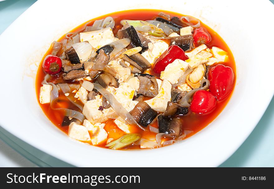 Delicious Chinese dish in white plate on restaurant table. Delicious Chinese dish in white plate on restaurant table