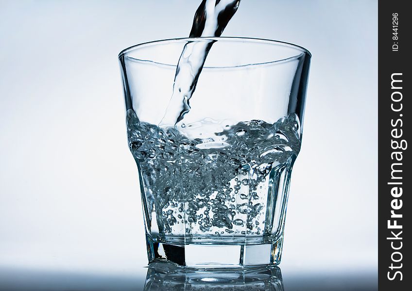 Glass of pouring water with a bubbles