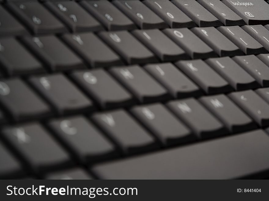 Black laptop keyboard selective focus. Black laptop keyboard selective focus